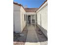 Inviting gated courtyard leading to the front door with desert landscaping at 7133 Tropical Island Cir, Las Vegas, NV 89129