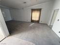 Spacious carpeted living room featuring neutral walls and ample natural light at 7133 Tropical Island Cir, Las Vegas, NV 89129