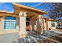 Inviting home showcasing an arched front entrance with decorative pillars and a cozy seating area at 720 Florida St, Pahrump, NV 89048