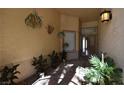 Inviting entryway with plants and brick flooring at 7624 Desert Delta Dr, Las Vegas, NV 89128