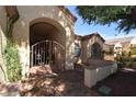 Beautiful gated entrance into courtyard with brick flooring at 7624 Desert Delta Dr, Las Vegas, NV 89128