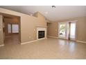 Spacious living room featuring tile floors and fireplace at 7624 Desert Delta Dr, Las Vegas, NV 89128