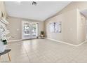 Spacious living room featuring tile flooring, neutral walls, and French doors to a patio at 7624 Desert Delta Dr, Las Vegas, NV 89128