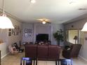 Spacious living room featuring neutral walls, pendant lights and a ceiling fan at 8494 Langhorne Creek St, Las Vegas, NV 89139