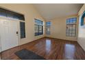 Bright, open-plan living room with gleaming hardwood floors and large windows flooding the space with natural light at 8869 Dove Cove Dr, Las Vegas, NV 89129