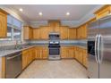 Bright kitchen features stainless steel appliances, granite countertops, and ample wood cabinetry at 9678 Swaying Elms Ct, Las Vegas, NV 89147