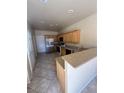 Spacious kitchen featuring tile flooring, stainless refrigerator, and laminate countertops at 1123 Scenic Crest Dr, Henderson, NV 89052