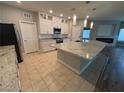 Modern kitchen featuring white cabinets, granite countertops, and a stainless steel microwave at 11260 Burning River St, Las Vegas, NV 89183