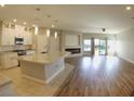 Open floor plan of the Kitchen showcasing a large granite island, a fireplace, and stainless steel appliances at 11260 Burning River St, Las Vegas, NV 89183