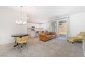 Bright living room featuring modern furniture, neutral colors, and sliding glass doors at 1338 Ossa St, Henderson, NV 89052