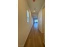 Hallway with hardwood floors leading to a living area and a window with blinds at 1586 Crowned Eagle St, Las Vegas, NV 89138