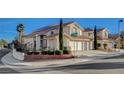 Charming two-story home featuring a terracotta roof, a three-car garage, and manicured landscaping at 1800 Summit Pointe Dr, Las Vegas, NV 89117