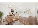 Bright, open-concept living space featuring modern lighting, a fireplace, and seamless access to the kitchen at 2301 W El Camino Ave, Las Vegas, NV 89102