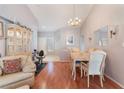 Open floor plan showcases the dining area with hardwood floors and a decorative chandelier fixture at 2735 Faiss Dr, Las Vegas, NV 89134