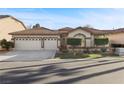 Charming single-story home featuring a three-car garage, desert landscaping, and a welcoming entrance at 283 Parisian Springs Ct, Las Vegas, NV 89148