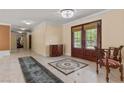 Spacious foyer with marble floors, decorative rug, elegant lighting, and carved wood front doors at 3585 Tobias Ln, Las Vegas, NV 89120