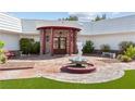 Detailed entryway with a circular drive, fountain, red brick columns, and double entry doors at 3585 Tobias Ln, Las Vegas, NV 89120