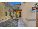 Inviting front entrance with a covered porch, enhanced by manicured landscaping and stylish exterior lighting at 3741 Lily Haven Ave, Las Vegas, NV 89120