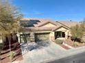 Inviting one-story residence featuring a spacious three-car garage, desert landscaping, and efficient solar panels at 4058 Helens Pouroff Ave, North Las Vegas, NV 89085