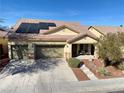 Attractive single-story home with a three-car garage, desert landscaping, solar panels, and a welcoming front porch at 4058 Helens Pouroff Ave, North Las Vegas, NV 89085