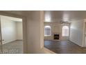 Spacious living room with fireplace, ceiling fan, and modern vinyl floors at 4555 Sahara Ave # 252, Las Vegas, NV 89104