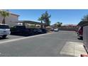 Community parking area showing assigned covered parking and mature landscaping at 4555 Sahara Ave # 252, Las Vegas, NV 89104