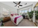 Bright bedroom with a bay window, ceiling fan, and large closet with mirrored doors at 4557 Bersaglio St, Las Vegas, NV 89135