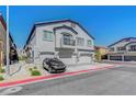 Well-maintained townhome with attached garages, balcony, and attractive landscaping at 4640 Flower Moon Ave # 102, North Las Vegas, NV 89084