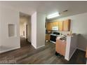 View of kitchen with light wood cabinets, laminate countertop, and open access to main living areas at 4730 E Craig Rd # 1106, Las Vegas, NV 89115