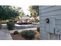 A view of a condo's exterior showcasing ample parking space and lush green trees at 4770 Topaz St # 79, Las Vegas, NV 89121