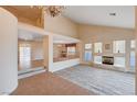 Spacious living room featuring vaulted ceilings, an open floor plan, a fireplace, and natural light at 7623 Calm Passage Ct, Las Vegas, NV 89139