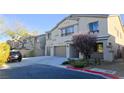 Attractive two-story home featuring a three-car garage and vibrant landscaping for curb appeal at 8223 Saddleback Ledge Ave, Las Vegas, NV 89147