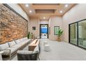 Bright seating area with stone accent wall and a view of the city at 9 Stonecutter Ct, Henderson, NV 89012