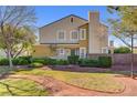 Inviting two-story home featuring a well-maintained lawn and lush landscaping at 917 Collingtree St, Las Vegas, NV 89145