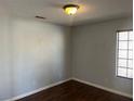 A simple bedroom with wood floors, neutral walls, and a window at , Henderson, NV 89074