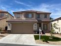 Charming two-story home featuring a well-manicured front yard, a two car garage and a welcoming entrance at 10332 George Hart Ct, Las Vegas, NV 89129