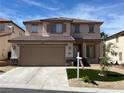 Charming two-story home featuring a well-manicured front yard, a two car garage and a welcoming entrance at 10332 George Hart Ct, Las Vegas, NV 89129