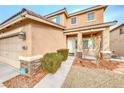 Inviting home exterior with rock accents, desert landscaping, and charming curb appeal at 10332 George Hart Ct, Las Vegas, NV 89129