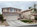 Charming two-story home with a two-car garage and xeriscaped front yard at 10332 George Hart Ct, Las Vegas, NV 89129