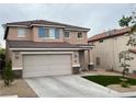 Charming two-story home with a two-car garage and xeriscaped front yard at 10332 George Hart Ct, Las Vegas, NV 89129
