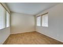 Bright bedroom with wood flooring, neutral walls, and large windows dressed with blinds at 1290 Corista Dr, Henderson, NV 89052