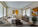 Living room staged with sofa, table, rugs, and decorative art at 1290 Corista Dr, Henderson, NV 89052