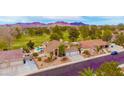 Aerial view of a well-landscaped home featuring a private pool and a golf course in the background at 1584 Bermuda Dunes Dr, Boulder City, NV 89005