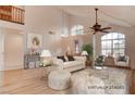 Bright living room with vaulted ceilings, large windows, and stylish furnishings, perfect for entertaining at 1584 Bermuda Dunes Dr, Boulder City, NV 89005