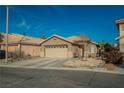 Inviting single story home features a two car garage and low maintenance desert landscaping at 204 Mchenry St, Las Vegas, NV 89144