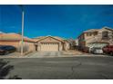 Inviting single story home features a two car garage and low maintenance desert landscaping at 204 Mchenry St, Las Vegas, NV 89144