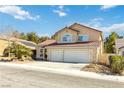 Inviting two-story home featuring a red tile roof, front yard landscaping, and a two-car garage at 3012 Pier Harbor Dr, Las Vegas, NV 89117