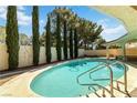 Backyard pool with a refreshing blue tone, complemented by the tall privacy trees at 3012 Pier Harbor Dr, Las Vegas, NV 89117