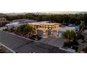 Aerial view of a modern home with a large driveway and three-car garage at 3452 Spanish Winds Ct, Las Vegas, NV 89141