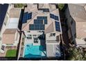 Aerial view of a home showcasing its solar panels and private backyard pool oasis at 3717 Moonshine Falls Ave, North Las Vegas, NV 89085